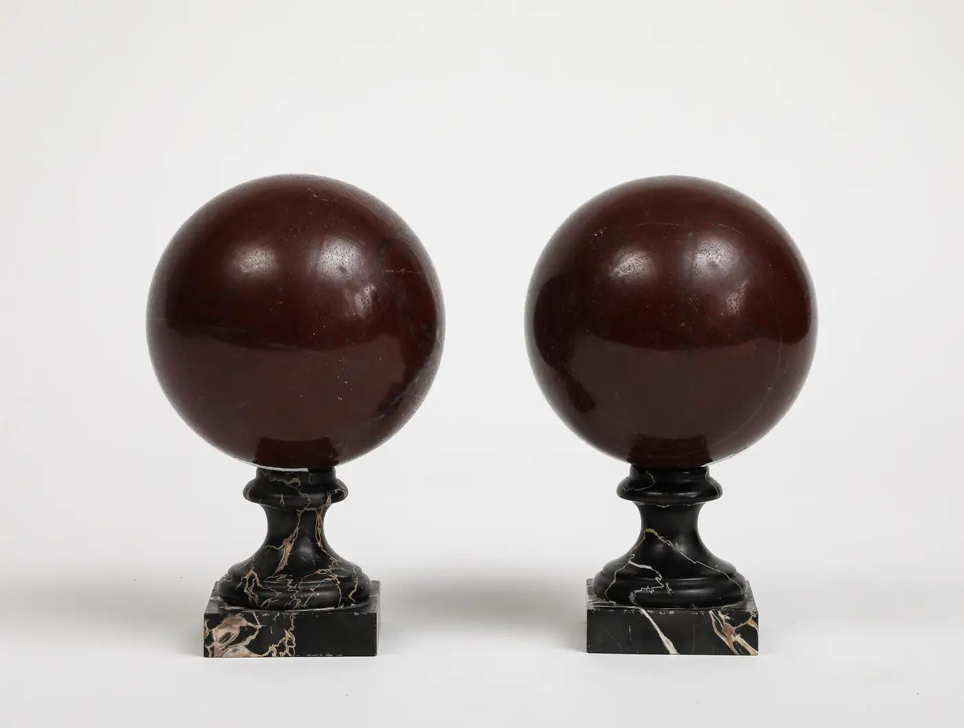 Pair of 19th Century Red Marble Spheres on Black Marble Stands