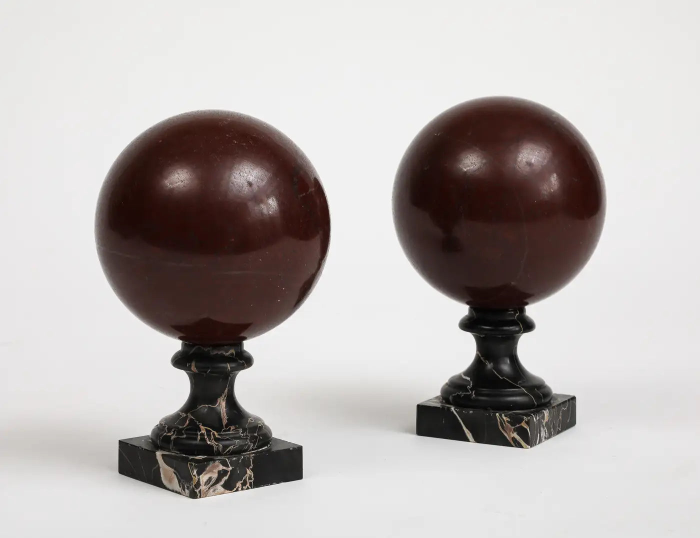Pair of 19th Century Red Marble Spheres on Black Marble Stands
