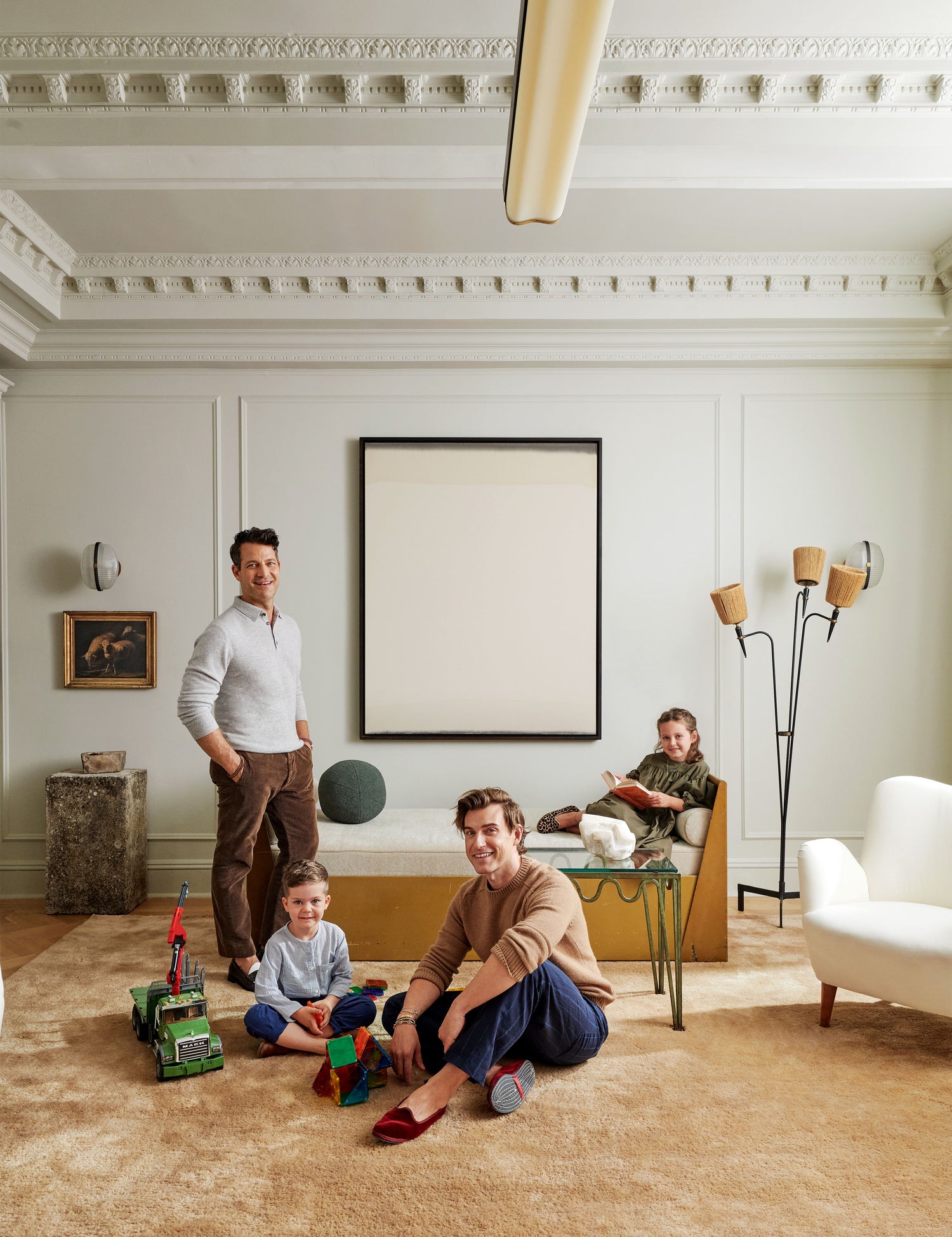 Nate, Jeremiah and their children relax in the living room.