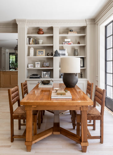An antique wooden dining set adds warmth to the bright interiors of Nate Berkus and Jeremiah Brent's Hancock Park estate.