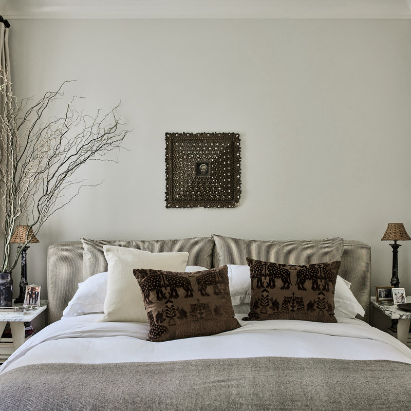 A tonal and textural primary bedroom, featuring earthy hues and materials, designed by Nate Berkus and Jeremiah Brent.