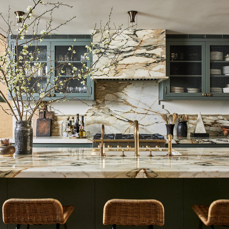 A West Village kitchen designed by Nate Berkus and Jeremiah Brent that juxtaposes rustic materials with clean lines and neutral tones with unexpected blues.