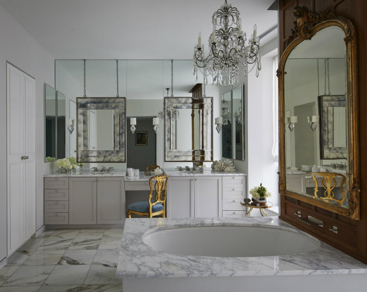 Mirrored surfaces and marble add dimension to this Chicago apartment bathroom, designed by Nate Berkus Associates.