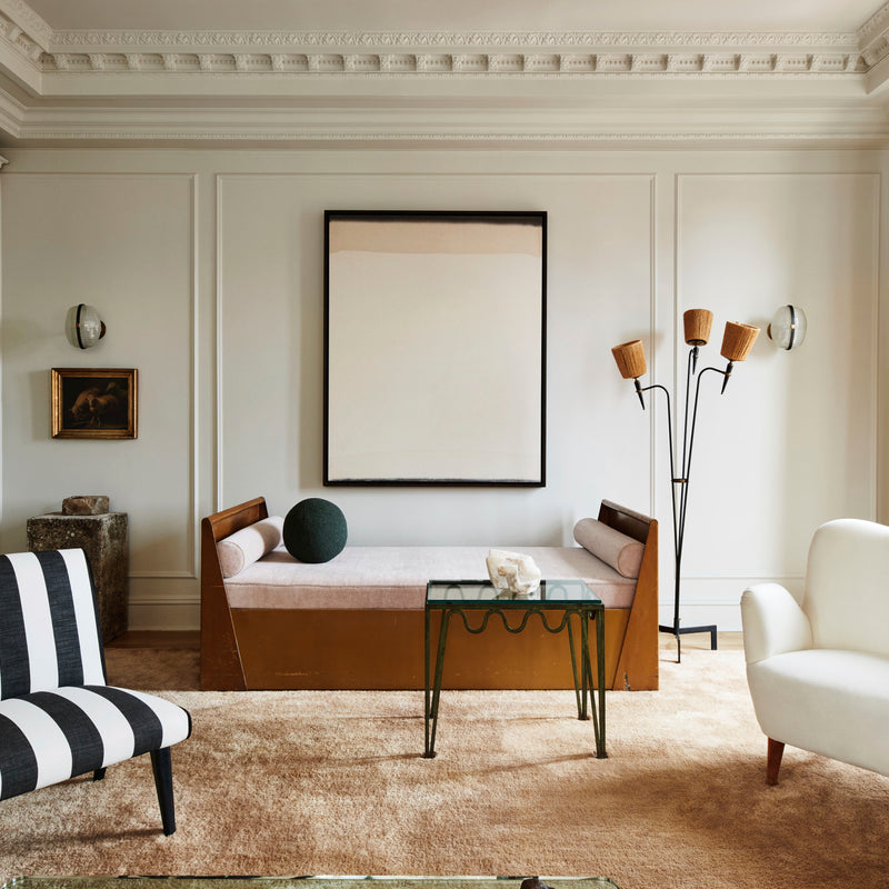 A curated seating area with statement lighting and architectural details by Nate Berkus and Jeremiah Brent.