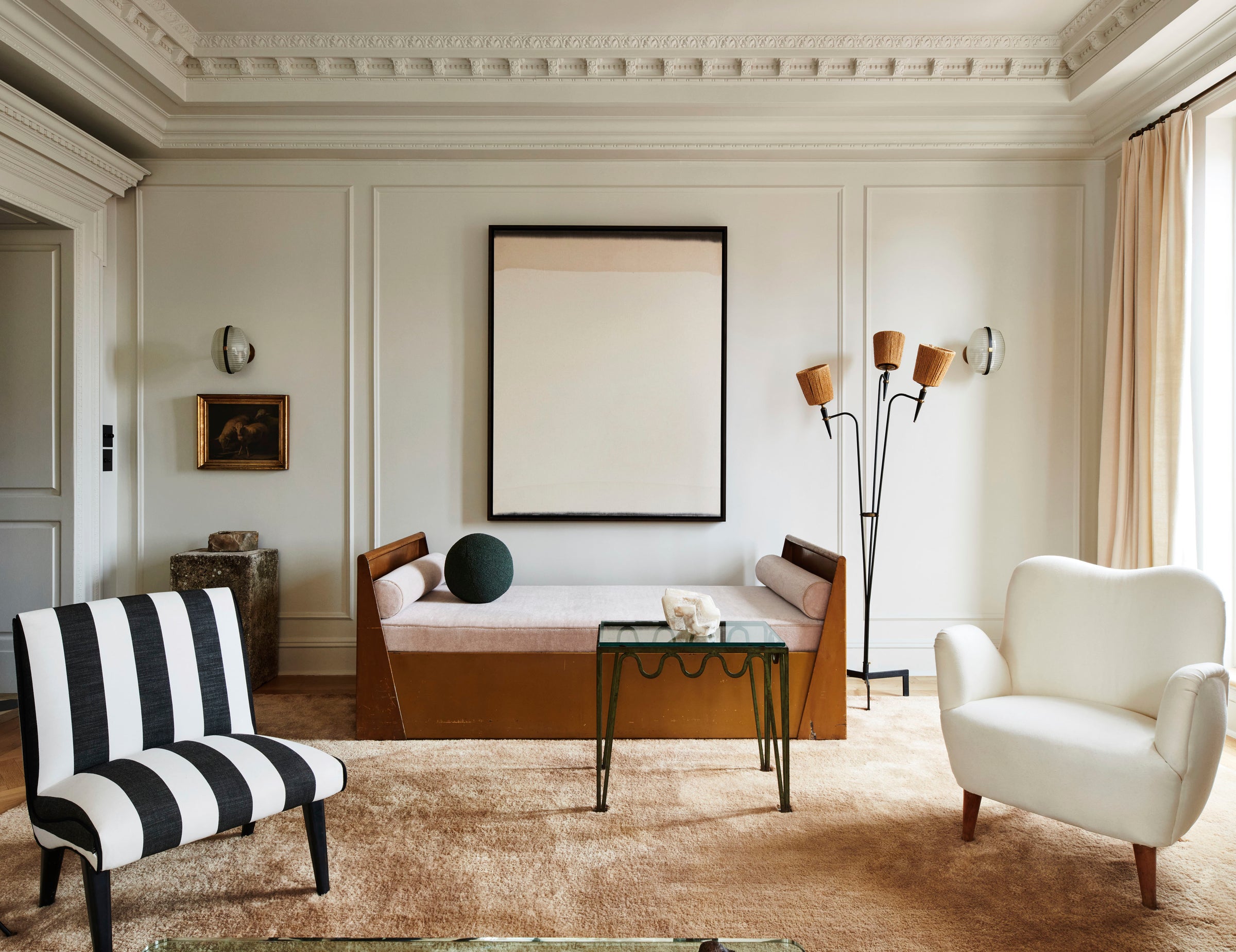 A curated seating area with statement lighting and architectural details by Nate Berkus and Jeremiah Brent.