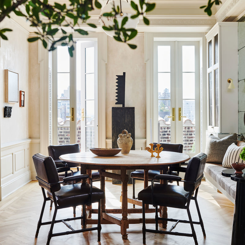 Natural light streams in through french doors in the dining nook of a Manhattan home, designed by Nate Berkus and Jeremiah Brent. 