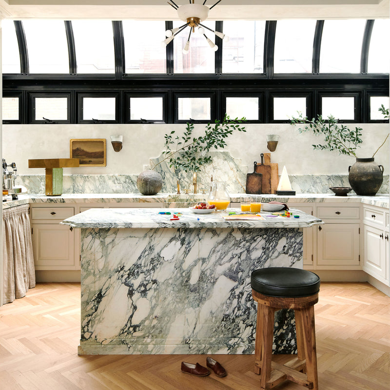A marble-clad island is the focal point of this contemporary, organic kitchen by Nate Berkus and Jeremiah Brent.
