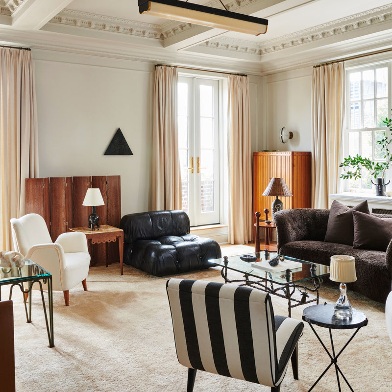 A gallery-like living area of architectural details and curated antique and vintage furnishings, designed by Nate Berkus and Jeremiah Brent.